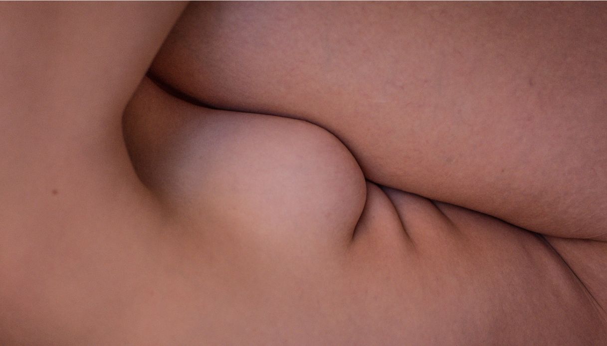 corpo di donna nuda piegato su se stesso