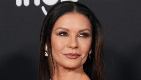 Catherine Zeta-Jones tra gli uomini della sua vita: abito asimmetrico nero e oro